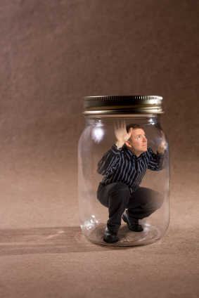 Guy Sits On Glass Jar